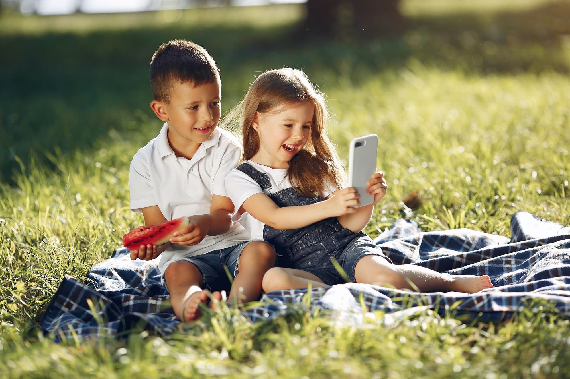 Cute children with watermelons in a park